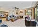 Spacious living room with fireplace, tiled floors, access to the bedroom, and bright natural light at 7700 E Gainey Ranch Rd # 124, Scottsdale, AZ 85258