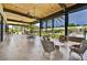 Covered outdoor patio with seating, dining area, and views of the pool and community at 7700 E Gainey Ranch Rd # 124, Scottsdale, AZ 85258