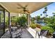 Inviting covered patio with a ceiling fan and scenic views of the lake and lush landscaping at 7700 E Gainey Ranch Rd # 124, Scottsdale, AZ 85258