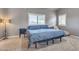 Bedroom features a ceiling fan, two large windows, and a large bed and matching end tables at 8207 W Planada Ln, Peoria, AZ 85383