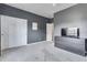 A bedroom with gray walls, white closet doors, and a gray dresser with a TV on top at 8207 W Planada Ln, Peoria, AZ 85383