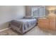 Cozy bedroom showcasing natural light, a neutral color scheme, and a comfortable full-size bed at 8207 W Planada Ln, Peoria, AZ 85383