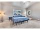 Bedroom features a ceiling fan, two large windows, and a large bed and matching end tables at 8207 W Planada Ln, Peoria, AZ 85383