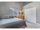 Bedroom boasts lots of natural light and neutral colors, complemented by light wood furniture at 8207 W Planada Ln, Peoria, AZ 85383