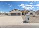 Charming single-story home with a three car garage and desert landscaping at 8207 W Planada Ln, Peoria, AZ 85383