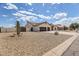 Desert landscaping surrounds this single-story home with three-car garage and tile roof at 8207 W Planada Ln, Peoria, AZ 85383