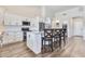 Modern kitchen with a large island, white cabinetry, and stainless steel appliances at 8207 W Planada Ln, Peoria, AZ 85383