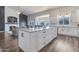 Bright, open kitchen features a large island with granite countertops, plenty of cabinet space, and modern appliances at 8207 W Planada Ln, Peoria, AZ 85383