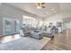 Open-concept living space with seamless flow to the kitchen and dining area, enhanced by hardwood floors and abundant light at 8207 W Planada Ln, Peoria, AZ 85383