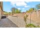 Low maintenance backyard features gravel ground cover, a brick perimeter wall, and a small potted plant at 8465 W Andrea Dr, Peoria, AZ 85383