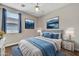 Cozy bedroom with modern decor, plush bedding, and ample natural light at 8465 W Andrea Dr, Peoria, AZ 85383