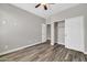 Bedroom featuring laminate wood flooring, neutral walls, and a double-door closet at 8465 W Andrea Dr, Peoria, AZ 85383