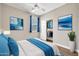Comfortable bedroom featuring an closet, modern decor, and attractive ocean themed art at 8465 W Andrea Dr, Peoria, AZ 85383