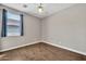 Neutral secondary bedroom with laminate wood flooring and natural light at 8465 W Andrea Dr, Peoria, AZ 85383