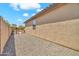 Side yard showing the stucco exterior and rock landscaping for low maintenance at 8465 W Andrea Dr, Peoria, AZ 85383