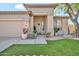 Inviting front entrance with a well-manicured lawn, decorative plants, and a neutral color scheme at 8465 W Andrea Dr, Peoria, AZ 85383