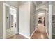 Hallway featuring wood and tile flooring with kitchen and bathroom access at 8465 W Andrea Dr, Peoria, AZ 85383