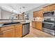 Kitchen with stainless steel appliances, laminate countertops, and a view of the living room at 8465 W Andrea Dr, Peoria, AZ 85383
