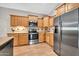 Kitchen with stainless steel appliances and honey colored cabinets at 8465 W Andrea Dr, Peoria, AZ 85383