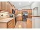 Well-lit kitchen with wood cabinets, stainless steel appliances, and tile backsplash at 8465 W Andrea Dr, Peoria, AZ 85383
