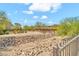 View of desert landscape featuring rocks, native trees and shrubs, and a paved walkway at 8465 W Andrea Dr, Peoria, AZ 85383