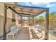 Covered outdoor living area with bar, seating, and a view of the backyard at 8465 W Andrea Dr, Peoria, AZ 85383