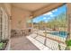 Covered patio offers seating overlooking backyard with pool views at 8465 W Andrea Dr, Peoria, AZ 85383