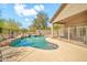 Sparkling swimming pool with rock features and lush desert plants surrounding the backyard at 8465 W Andrea Dr, Peoria, AZ 85383