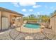 Enclosed backyard pool with rock landscaping, covered patio, and desert vegetation offers a refreshing outdoor space at 8465 W Andrea Dr, Peoria, AZ 85383
