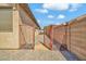 Gated side yard with gravel ground cover and access to the backyard at 8465 W Andrea Dr, Peoria, AZ 85383