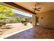 Back patio area with ceiling fan and desert landscaping with mountain views at 8647 W Lariat Ln, Peoria, AZ 85383