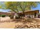 View of the backyard with desert landscaping, patio, and BBQ grill at 8647 W Lariat Ln, Peoria, AZ 85383