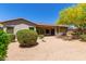Spacious backyard featuring desert landscaping, covered patio, and outdoor grill, perfect for entertaining at 8647 W Lariat Ln, Peoria, AZ 85383