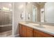 Bathroom with dual sink vanity, mirrors, and shower at 8647 W Lariat Ln, Peoria, AZ 85383