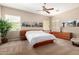 Spacious bedroom featuring neutral paint, ceiling fan, and world landmark canvas art above the bed at 8647 W Lariat Ln, Peoria, AZ 85383