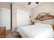 Bedroom featuring neutral paint, ceiling fan, and natural driftwood wall art at 8647 W Lariat Ln, Peoria, AZ 85383