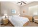 Bedroom featuring neutral paint, ceiling fan, dresser, night stand, and natural lighting at 8647 W Lariat Ln, Peoria, AZ 85383
