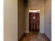 Entry courtyard featuring tiled floors and wooden privacy gate at 8647 W Lariat Ln, Peoria, AZ 85383