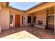 Open air entryway showcasing a natural wood front door and tiled patio at 8647 W Lariat Ln, Peoria, AZ 85383