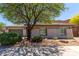 Exterior side view showcasing a beige home with desert landscaping at 8647 W Lariat Ln, Peoria, AZ 85383