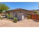 Side exterior view of a beige home with desert landscaping and fenced area at 8647 W Lariat Ln, Peoria, AZ 85383