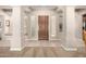 Beige foyer featuring neutral walls, tile floors, and a wood front door at 8647 W Lariat Ln, Peoria, AZ 85383
