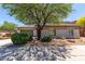 Charming home featuring a well-maintained front yard with mature landscaping, and a two-car garage at 8647 W Lariat Ln, Peoria, AZ 85383