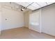Empty two-car garage with neutral painted walls and a window at 8647 W Lariat Ln, Peoria, AZ 85383