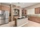 Open kitchen featuring wood cabinetry, granite countertops, and stainless steel appliances at 8647 W Lariat Ln, Peoria, AZ 85383
