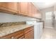 Laundry room featuring granite countertops and wood cabinetry at 8647 W Lariat Ln, Peoria, AZ 85383