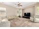 Light-filled living room with a comfortable white sofa, media center, and contemporary design at 8647 W Lariat Ln, Peoria, AZ 85383