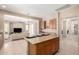 Open floor plan kitchen and living room featuring tile floors and neutral colors at 8647 W Lariat Ln, Peoria, AZ 85383