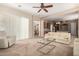 Spacious living room featuring neutral tones, an adjacent kitchen view, and abundant natural light at 8647 W Lariat Ln, Peoria, AZ 85383