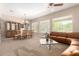 Inviting living room with stylish furnishings, a glass dining table, and abundant natural light at 8647 W Lariat Ln, Peoria, AZ 85383